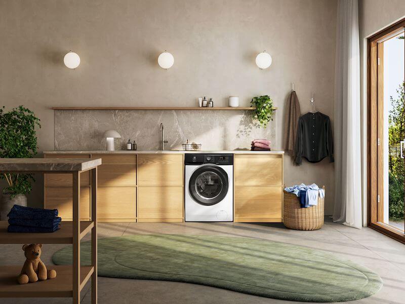 pralka electrolux w jasnej pralni z drewnianą zabudową Jak dobrać pojemność pralki do ilości prania w domu?